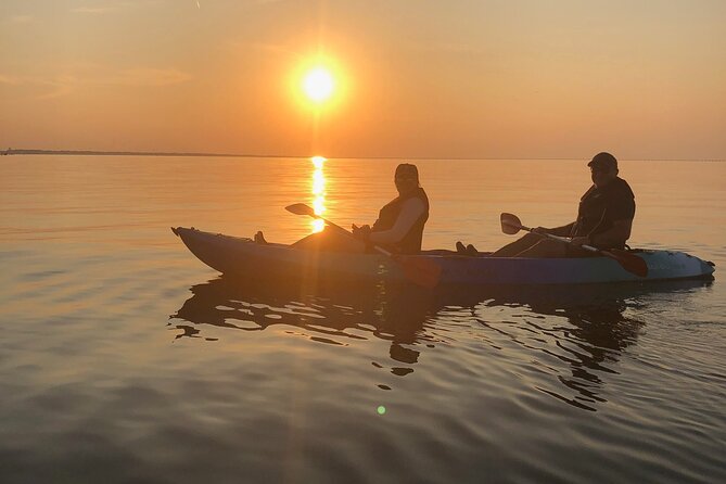 Sunset Dolphin Kayak Tours - Cape Henry Lighthouses and the Bridge-Tunnel glow at dusk